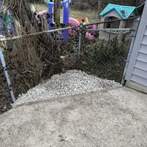 After: Overgrown fence corner cleared and graveled