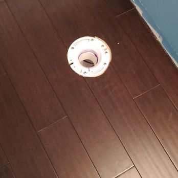 Flooring installed around a toilet flange